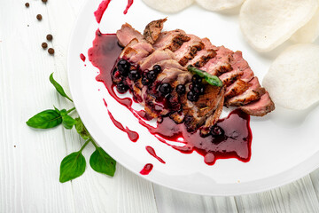 Sliced beef steak with berry sauce