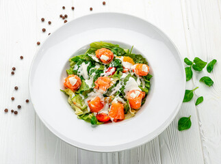 Salad with smoked salmon, fresh vegetables and cream cheese.