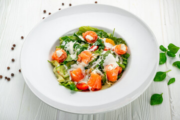 Salad with smoked salmon, fresh vegetables and cream cheese.