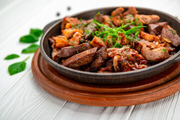 Meat and vegetables in frying pan