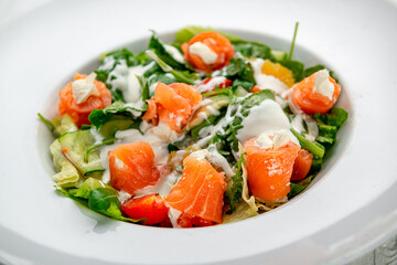 Salad with smoked salmon, fresh vegetables and cream cheese.