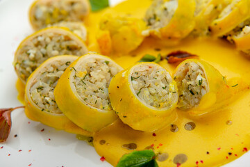 Stuffed squid with rice and vegetables with cheese sauce