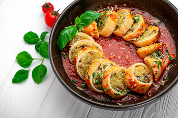 Squid stuffed with rice and vegetables in tomato sauce
