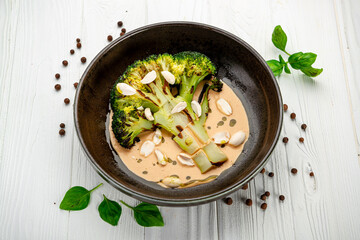 Grilled broccoli with creamy tomato sauce and walnuts