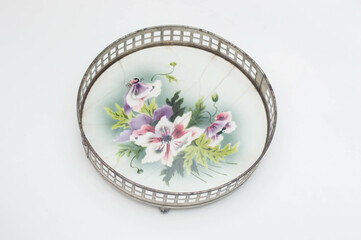 Fototapeta na wymiar Vintage porcelain tray with a metal corf