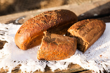 Whole and broken loaf of bread