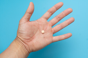 Individually wrapped pills on a blue background