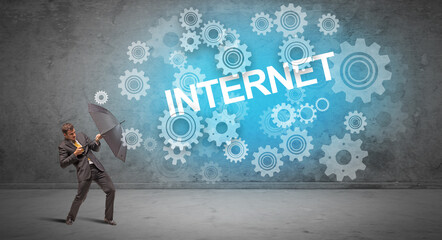 Fototapeta premium Businessman defending with umbrella concept