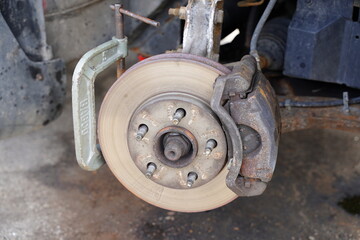 Vehicle metal rotor and front passenger brake caliper and brake pad