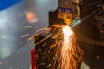 The fiber laser cutting machine cutting  machine cut the metal tube. - obrazy, fototapety, plakaty