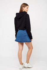 girl in a denim skirt and a black jacket