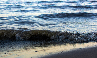 background sandy beach with waves and rocks