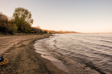 Volga river bank with waves and stones