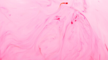 Light pink fluid art background. Blurred pink shapes on a liquid surface. Abstract wallpaper of soft pink shades