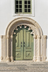 door and sculpture on the church in a square in Odiaxere, algarve, portugal