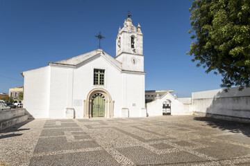 white church in a square in Odiaxere, algarve, portugal