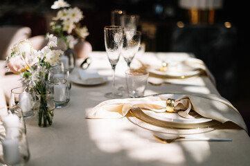 Dinner table decorated by candles and flowers. Wedding. Decor