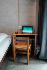 Fototapeta na wymiar Remote work with laptop inside room on a wooden desk