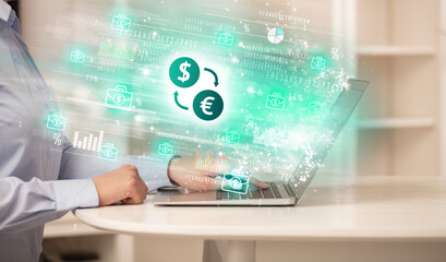 Young man watching stock market on laptop