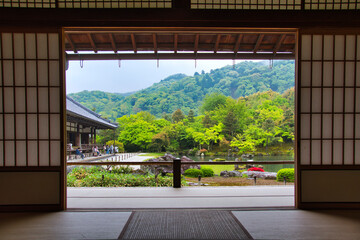 A beautiful Japanese garden with fresh green seen from the back of a Japanese-style guest room.    Arashiyama Kyoto Japan
