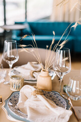 Boho wedding table set. vintage dining table with decorations, flowers and pampas grass  Boho style. Table set for an event, party, date or wedding.