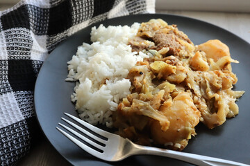 Cabbage bredie or stew. Traditional South African food. Cabbage bredie with potatoes, lamb chops and white rice