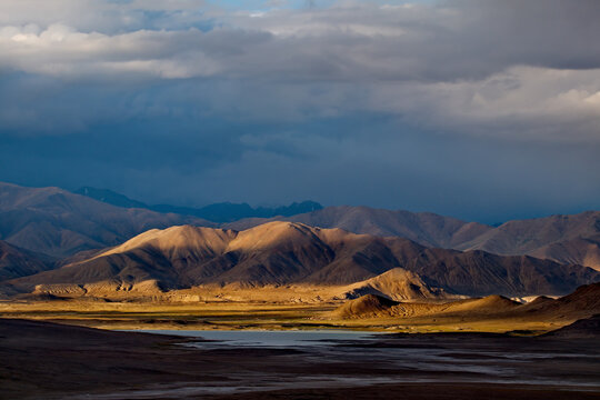 Tajikistan. A picturesque sunset in the valley of the mountainous desert lake Bulunkul on the northeastern section of the Pamir tract.