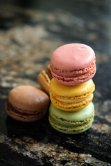 a stack of colorful macaron on marble