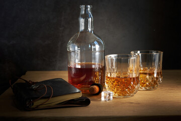 two glasses of whiskey and a bottle