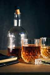 two glasses of whiskey and a bottle