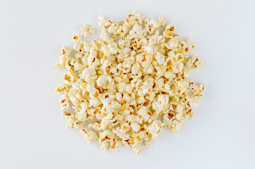 Heap of crispy popcorn on light background. Top view.