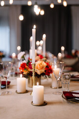 Autumn wedding table setting. Luxury stylish autumn wedding decor. Flowers and tableware on the wedding banquet. Styled romantic dinner in red color
