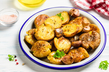 Salty herbed smashed baked potatoes. Copy space.
