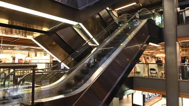 4K Time lapse of busy escalators with crowd of people at shopping mall in Bangkok