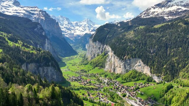 Picturesque Swiss valley of Lauterbrunnen on a sunny day, green alpine valley in Switzerland, famous tourist destination, the village of Lauterbrunnen