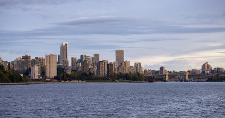 Fototapeta premium Modern City, Stanley Park, Buildings, beach and Burrard Bridge in False Creek on the West Coast of Pacific Ocean. Downtown Vancouver, British Columbia, Canada. Panoramic View. Sunset Sky