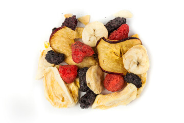 Freeze dried strawberry, blackberry, raspberry, apple, mango and banana pieces isolated over white. Top down view