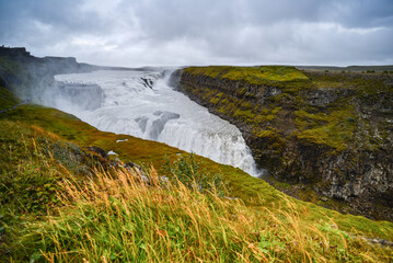 The famous Gullfoss waterfall, on the so-called Golden Circle tourist route, cascading down a narrow canyon on a rainy day, Iceland