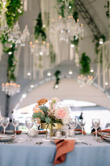 Amazing wedding table decoration with flowers on a round festive table