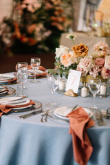 Amazing wedding table decoration with flowers on a round festive table
