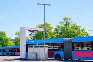 station for recharging electric public transport. Several urban shuttle buses are connected to...