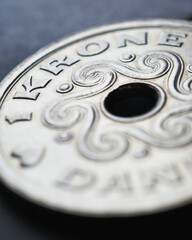 1 Danish krone coin closeup. National currency of Denmark. Money illustration for news about economy or finance. Loan and credit. Tax and inflation. Vertical stories. Macro