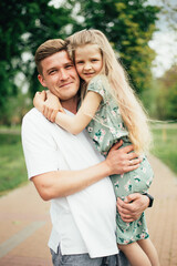 Fototapeta premium Dad with daughter outdoors. father's day