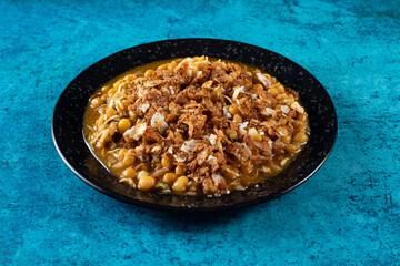 Spicy Chana chat masala chotpoti in a black dish isolated on background top view of indian, bangali and pakistani food chat pata food