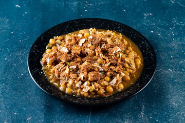 Spicy Chana chat masala chotpoti in a black dish isolated on background top view of indian, bangali and pakistani food chat pata food