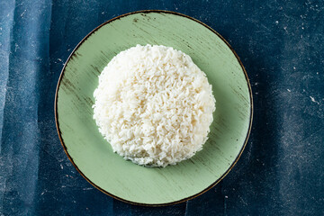 Plain boiled rice in a plate top view on marble background