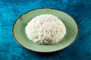 Plain boiled rice in a plate top view on marble background
