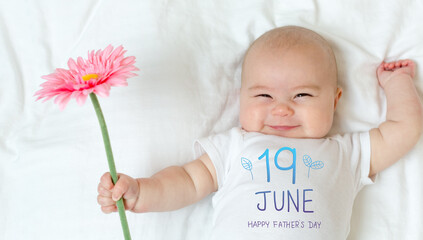 Father's Day message with baby girl holding a flower