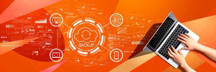 Backup concept with person using a laptop computer