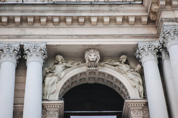 Two sculpture muse of allegory of arts and lion on the facade of the Opera and Ballet Theater in Lviv. Neo-renaissance in architecture.